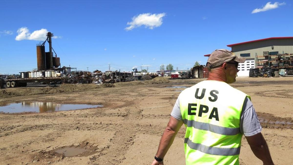 Paul Peronard, Environmental Protection Agency on-scene coordinator, shows journalists cleanup efforts at the site of an industrial fire at an oil supply company in Williston, N.D. on July 25, 2014. The EPA put out a call in April 2016 for comments about what regulations are in need of repeal, replacement or modification under President Donald Trump.
