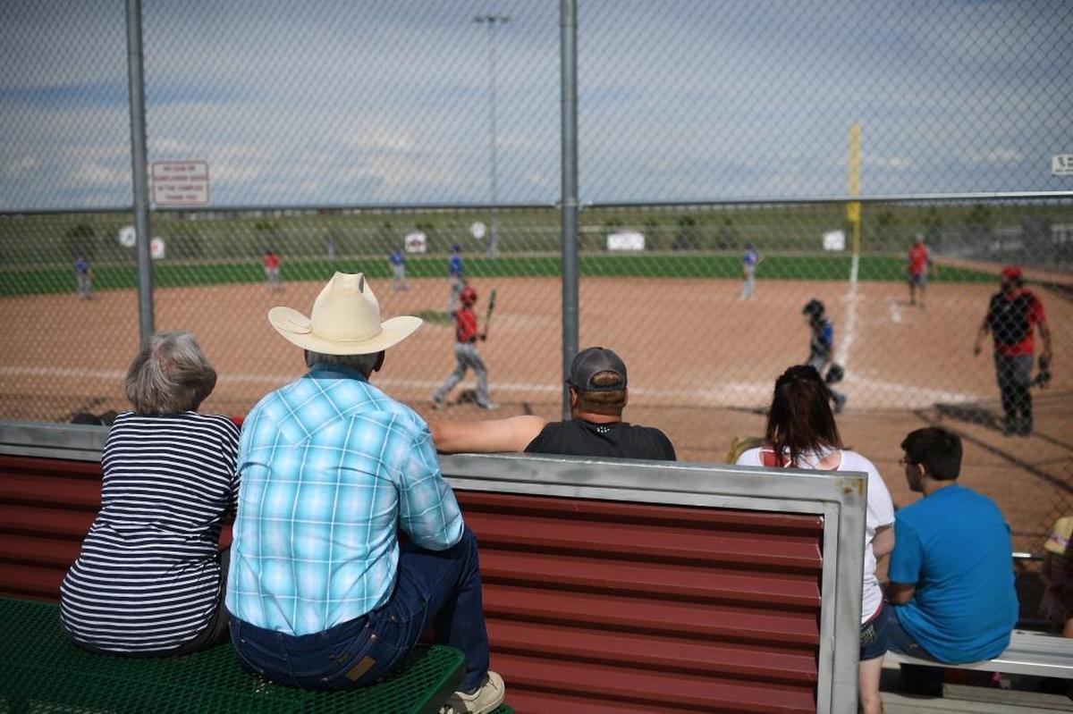 People watch a baseball game at the Energy Capital Sports Complex on a Sunday in Gillette, Wyoming.