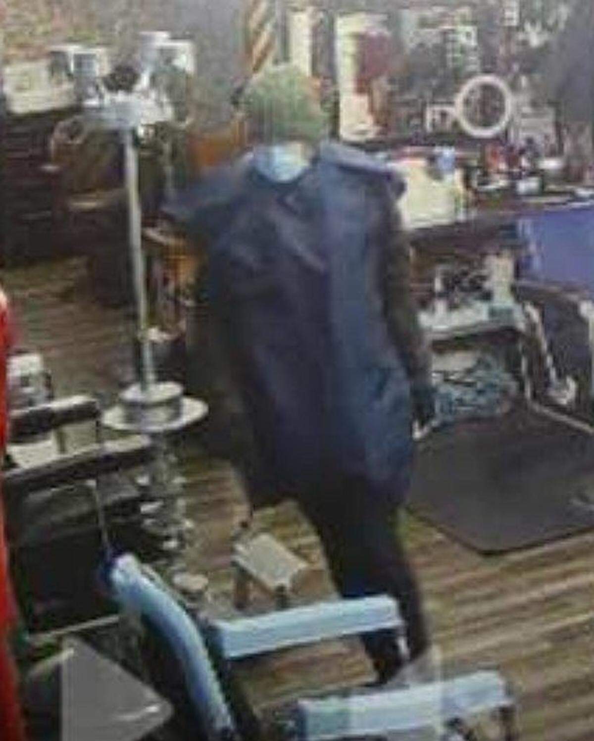 A suspected burglar was caught on camera wearing a green beanie and blue mask during a break-in at Barber Shack in Bellingham on Dec. 18.