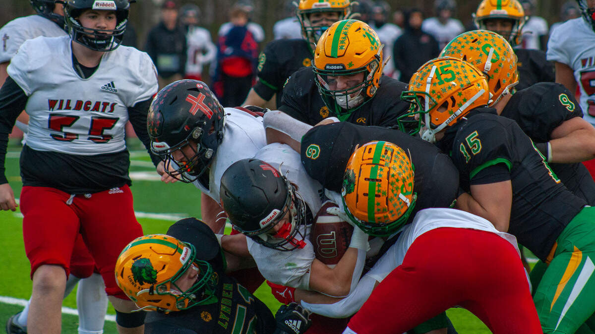 Lynden’s defense swarms the Wildcats offense on Saturday in Ferndale. The Wildcats were held to just 10 points but the Lions’ nine points could not topple Archbishop Murphy.