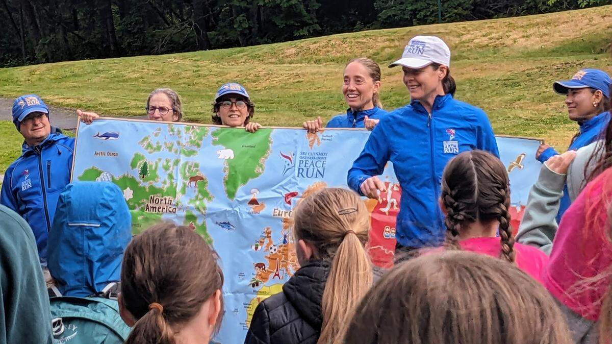Peace Run participants playing a game with Girls on the Run and Trail Blazers where they guess what country each runner is from at Lake Padden in Bellingham on June 27, 2024.