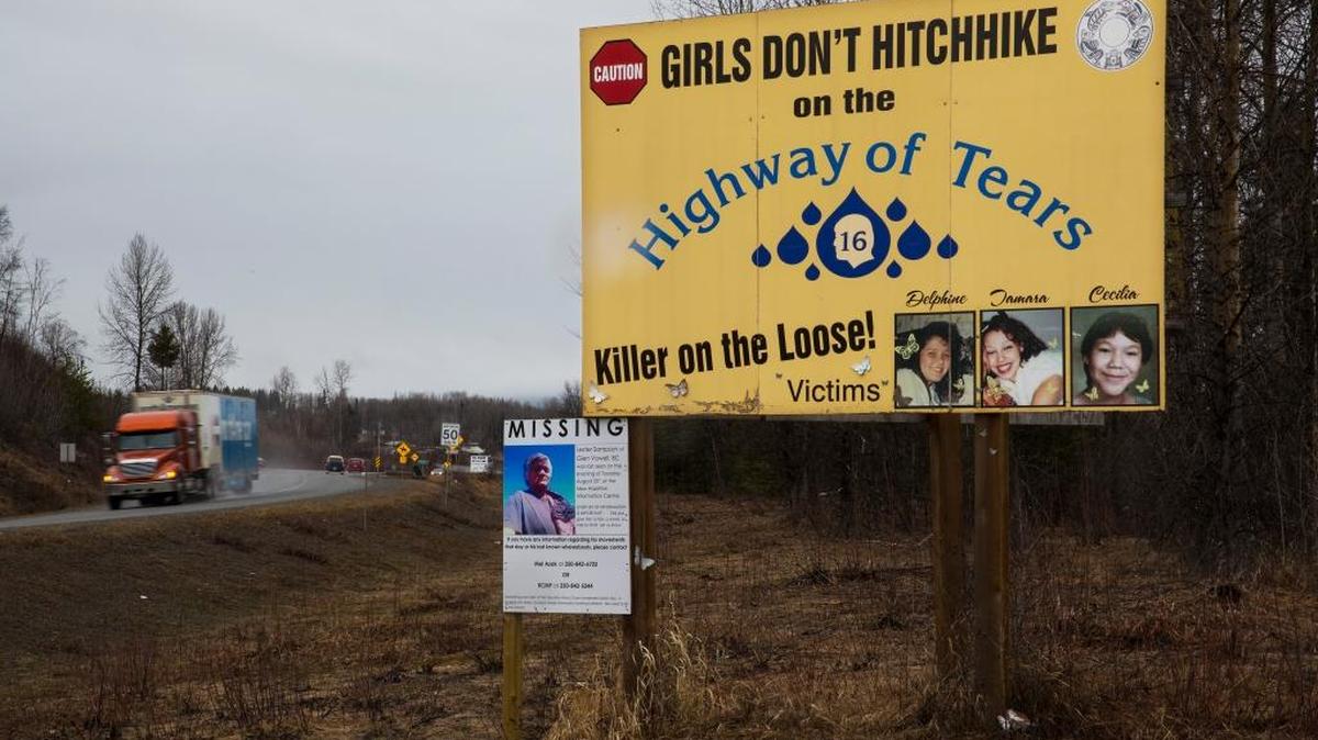 A sign along Highway 16 outside Smithers, Canada, warning girls against hitchhiking and displaying photos of some victims, March 23, 2016. Dozens of Canadian women and girls, most of them indigenous, have vanished or turned up dead near Highway 16, so many that residents call it the Highway of Tears.
