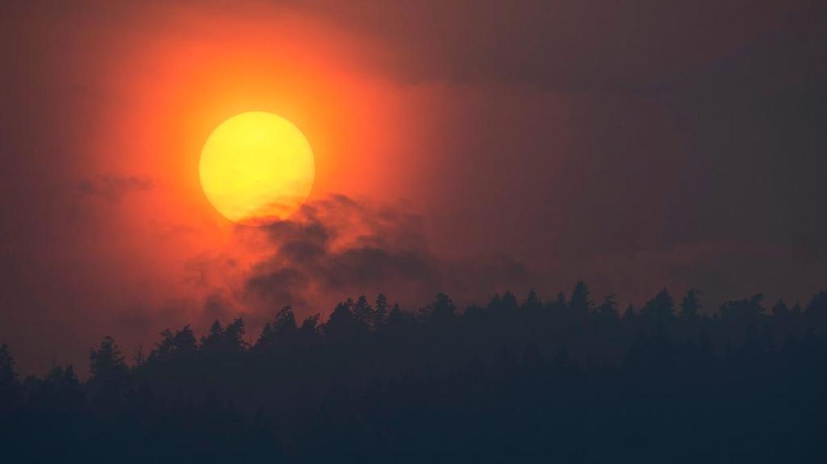 Smoke rises in front of the sun as a wildfire burns near Little Fort, British Columbia, Tuesday. Over a 100 wildfires are burning throughout British Columbia forcing thousands of residents to be on evacuation standby. (