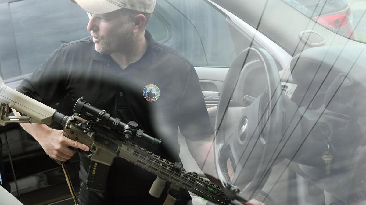 Todd Savage, a retired Marine who moved to north Idaho from San Francisco and opened American Redoubt Realty, displays a firearm that he routinely carries with him in Sandpoint, Idaho.