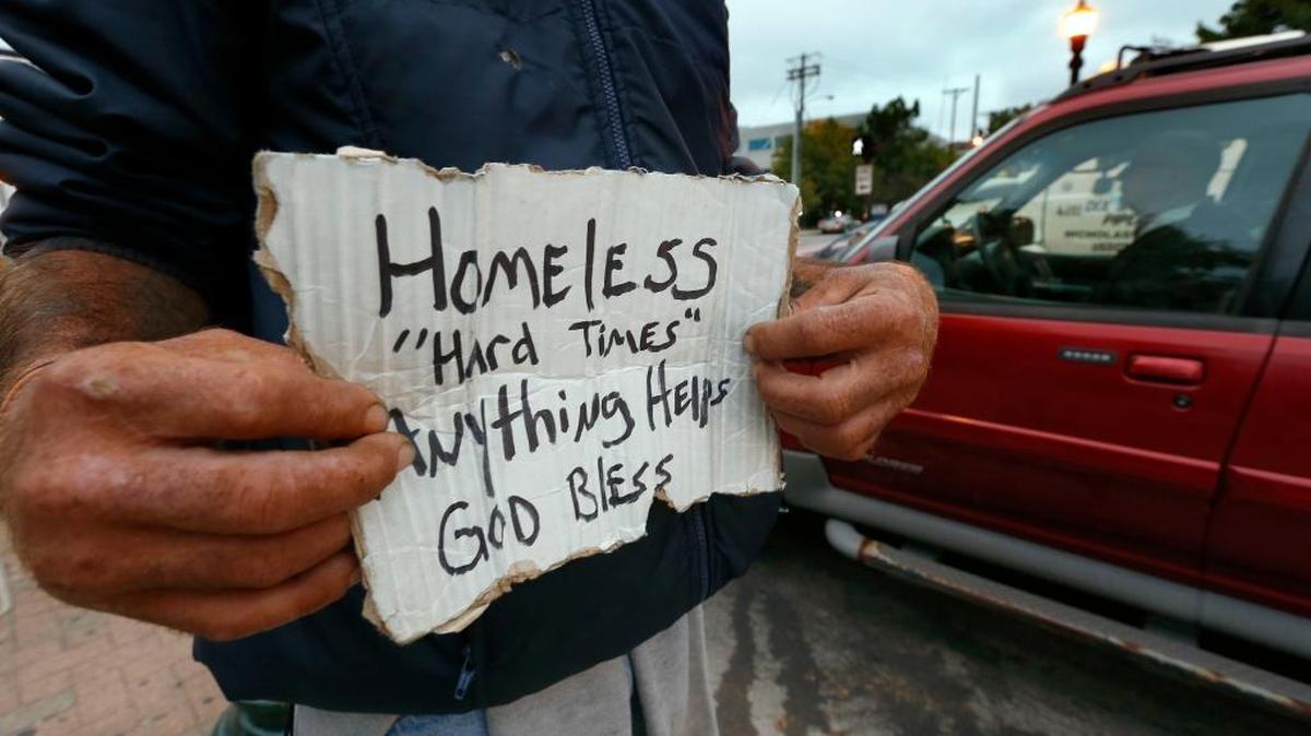 A man asks for help during the morning rush hour in Lexington, Kentucky, in October.