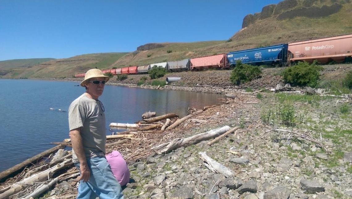 Bryan Jones, a farmer from Dusty, Wash., walks along the reservoir behind Little Goose Dam at the site of the town of Penawawa, which was covered when the dam was built. He ships his wheat on the river but is open to dam removal.
