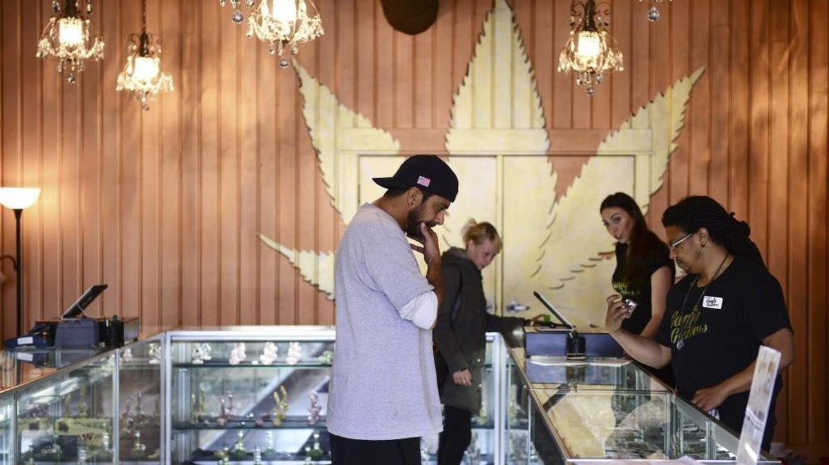 Customers shop at Ganja Goddess, a recreational marijuana store in Seattle, May 15, 2015.