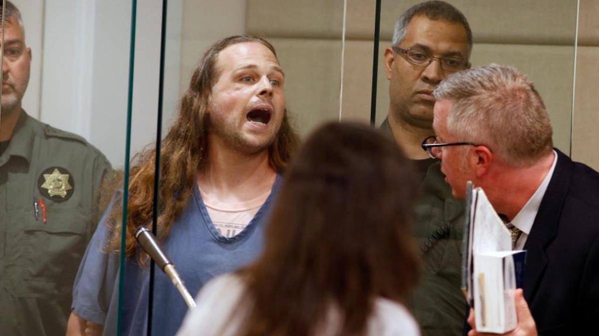 Jeremy Joseph Christian shouts as he is arraigned in Multnomah County Circuit Court in Portland, Ore., Tuesday, May 30, 2017. Authorities say Christian started verbally abusing two young women, including one wearing a hijab. When three men on the train intervened, police say, Christian attacked them, killing two and wounding one.