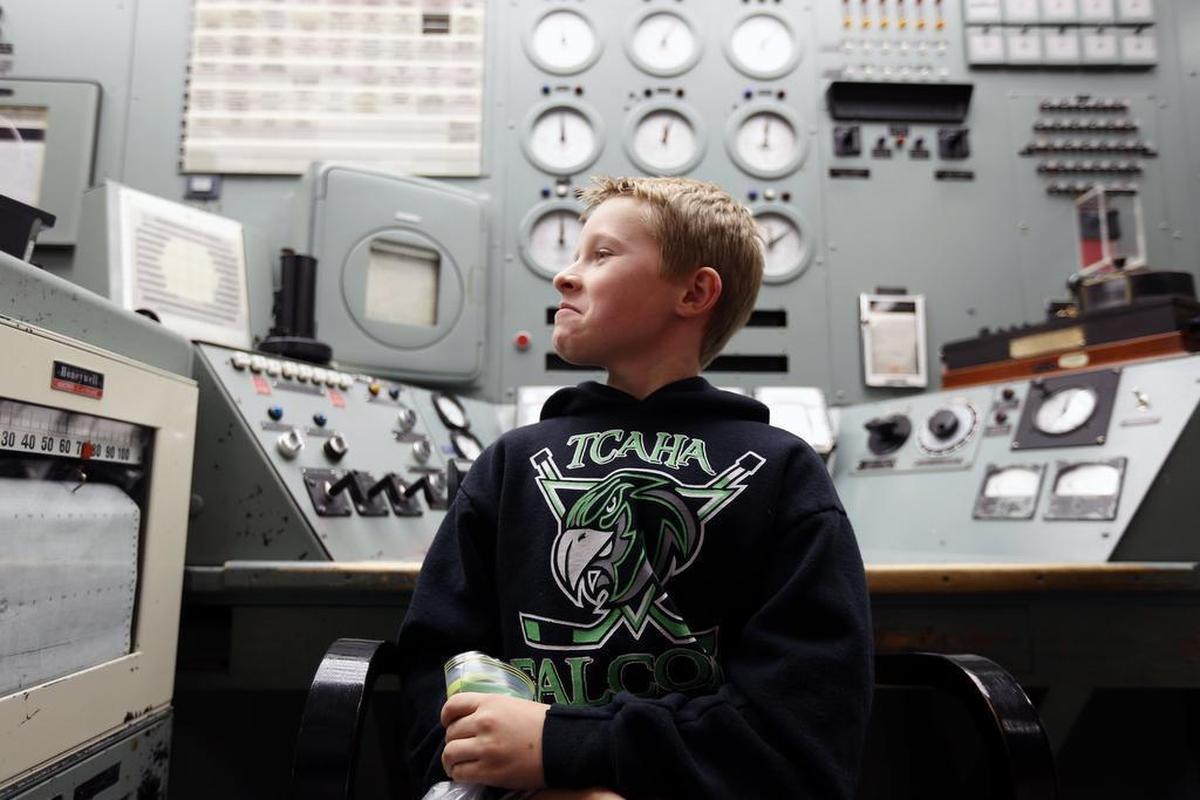 A student sits in the control room chair of B Reactor as his class attended a 2015 ceremony at the historic Hanford reactor to mark the creation of the Manhattan Project National Historic Park.