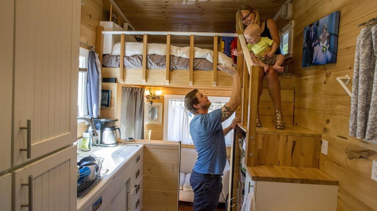 Peter and Shannon Johnson and their toddler Hart live in a tiny house of their own construction, August 11.