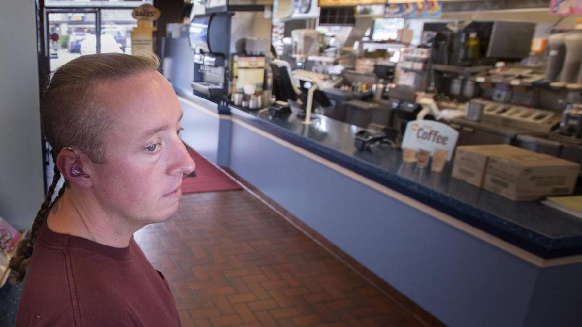 Garrett Harrell looks out at the area where he was punched while waiting for his order at a Lakewood Dairy Queen in late June and ended up in intensive care for a couple days. Harrell is hoping that the person who assaulted him will be arrested after telling his story on Tuesday.
