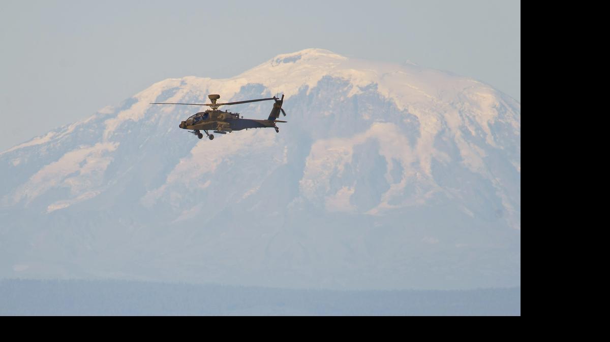 
An Apache attack helicopter files over the Yakima Training Center during an air-to-ground missile exercise at the Yakima Training Center, September 10, 2013. Mt. Adams is in the background.
