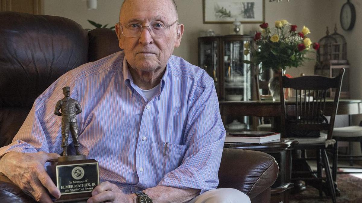 Ret. Marine Col. Elwin Hart holds a trophy made in honor of Elmer “Rabbit” Mathies, Jr., a close friend he served with during World War II. Mathies died with 1,100 Marines at the Battle of Tarawa, a small Pacific island. His remains and those of approximately 36 fellow soldiers were finally recovered last year. Hart hopes to present the likeness to remaining family members if they hold a funeral.