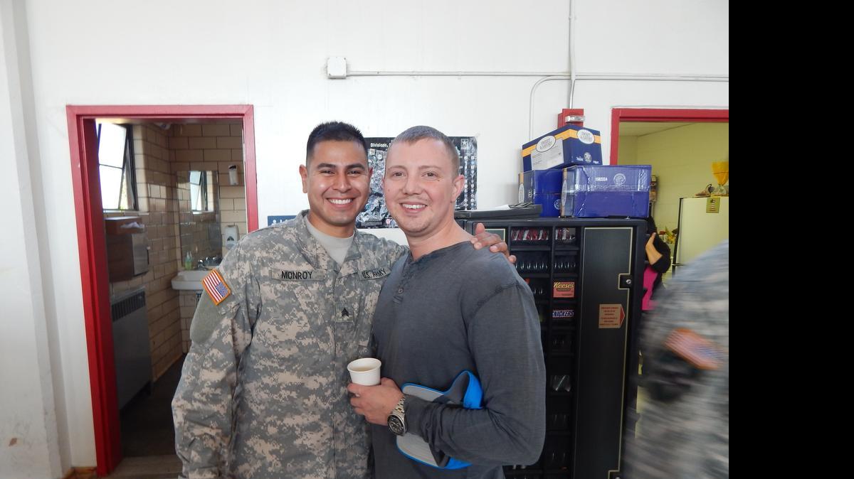 
Sgt. Pablo Monroy and his husband, Derrick, pose for a photo after Derrick was surprised with a Washington National Guard spouse award Saturday at the Puyallup Armory.
