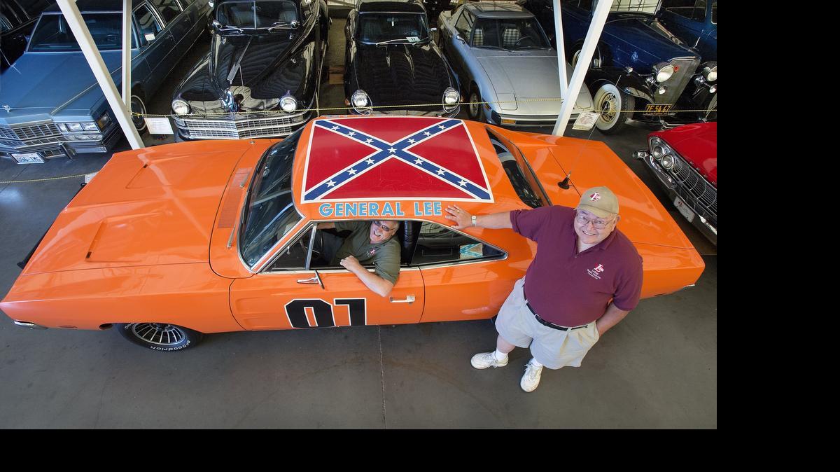 
Volunteers Dennis Laine, right, and Dennis Blowers pose with the General Lee, one of 200-plus custom-made versions of the car made for the popular 1980s television show “The Dukes of Hazzard.” The car, currently on display as part of the LeMay Family Collection in Spanaway, features the iconic Confederate flag decal on its roof. The museum has no plans to remove the decal in the wake public controversy, stating that “it’s part of history.”
