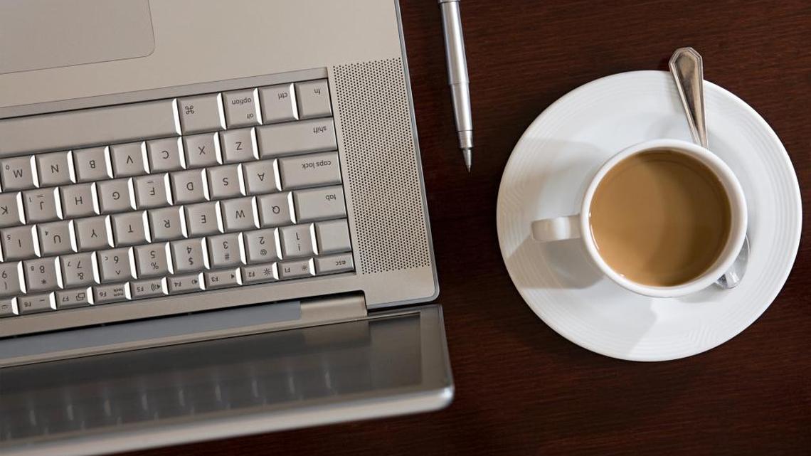 A laptop, pen and cup of coffee are positioned on a table. California state jobs are known for offering competitive benefits and enrollment in the nation’s largest state public pension plan.