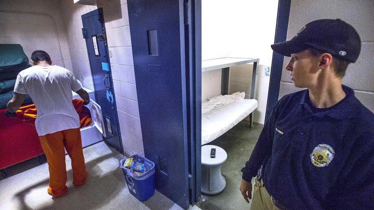 Corrections officer Sgt. Jen Stiner keeps watch as a trusty inmate does laundry at the Olympia jail on Thursday. The Olympia Police Department is wanting to hold fewer suspects on warrants for lower-level crimes in the city jail.