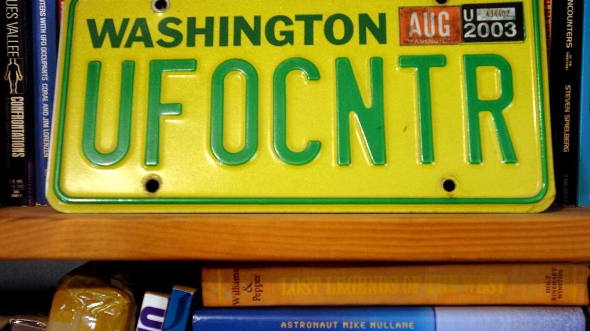 Peter Davenport, a ufologist, displays an old license plate in his office that is home to the National UFO Reporting Center in Harrington, Wash., Oct. 9, 2007.