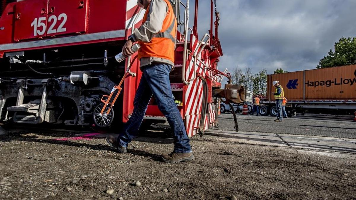 
Employees of Tacoma Rail at the scene of a train crash that cause a derailment near the rail crossing at the Port of Tacoma Road Thursday morning Sept. 3, 2015.
