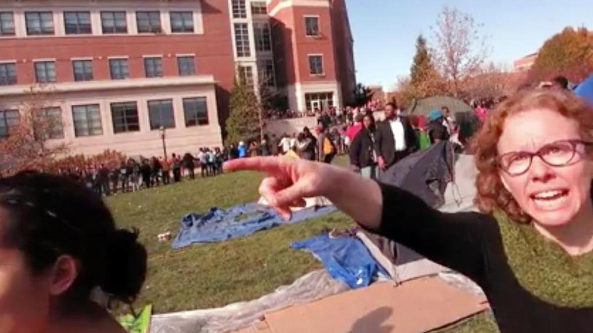 FILE - This Nov. 9, 2015 file frame grab provided by Mark Schierbecker shows Melissa Click, right, an assistant professor in the University of Missouri's communications, during a run-in with student journalists at a campus protest that followed the resignations of the university system's president and the Columbia campus' chancellor in Columbia, Mo. Click, who confronted a student photographer and another student videographer during the protests and called for 'muscle' to remove them, was charged with misdemeanor assault on Monday, Jan. 25, 2106.