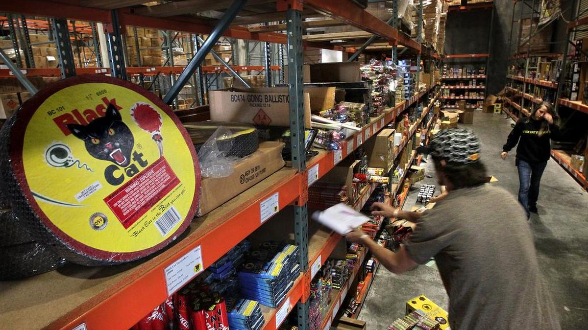 Workers Brandon Fegley and Kendra Niehaus fill orders for pyrotechnics lovers at Thunder Fireworks, Inc. in Frederickson, Washington on June 25, 2012. The company supplies “Black Cat” brand fireworks for the entire West Coast, including Alaska and Hawaii.
