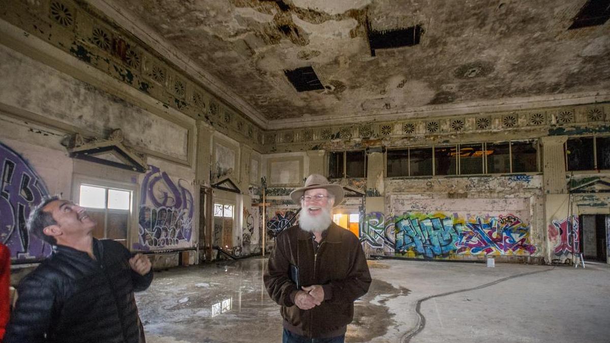 Mike McMenamin, co-owner of McMenamin's, a Portland-based developer of brewpubs and hotels, right, and architect George Signori take a look around the ballroom of the old Elks Lodge on Tuesday in downtown Tacoma. They plan to rehabilitate the building and open in the summer of 2017.
