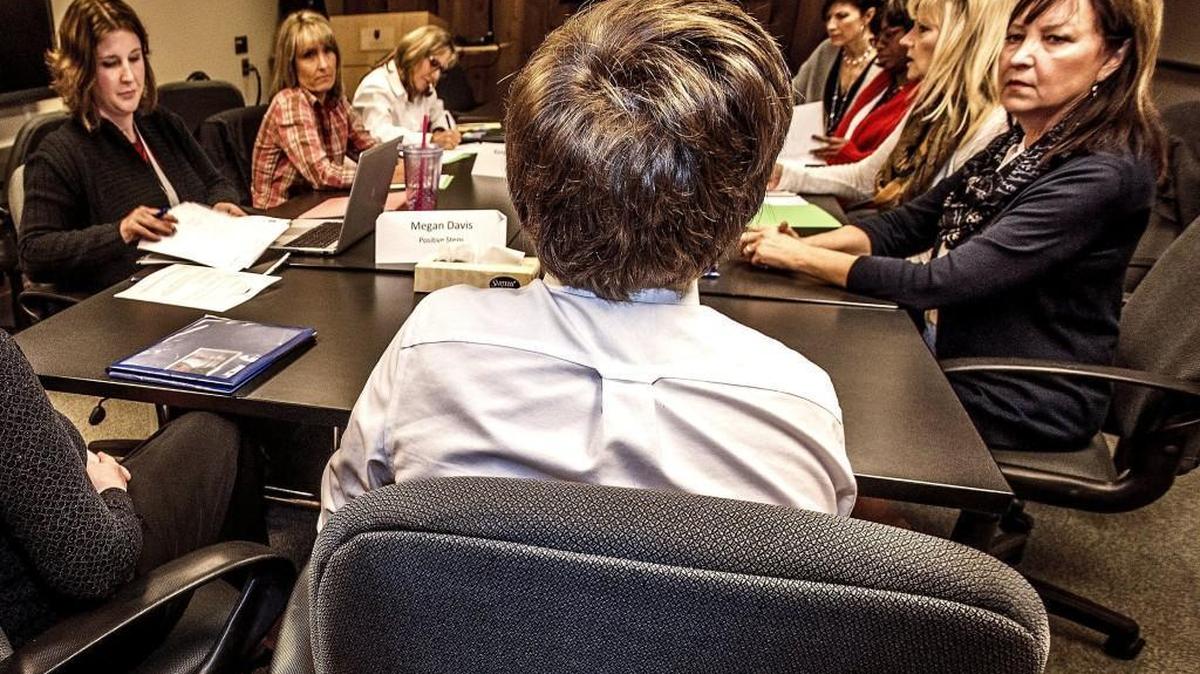 Members of the Puyallup School District’s truancy board interview a student and his mother at a hearing at the school district’s office in downtown Puyallup in November. The truancy board meetings involve representatives from the schools, the court system and school district.