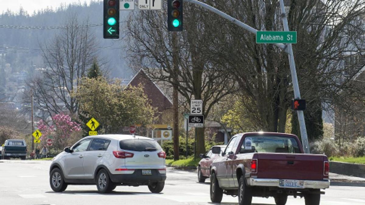 Vehicles turn left at the intersection of Cornwall Avenue and Alabama Street in Bellingham, Wash.