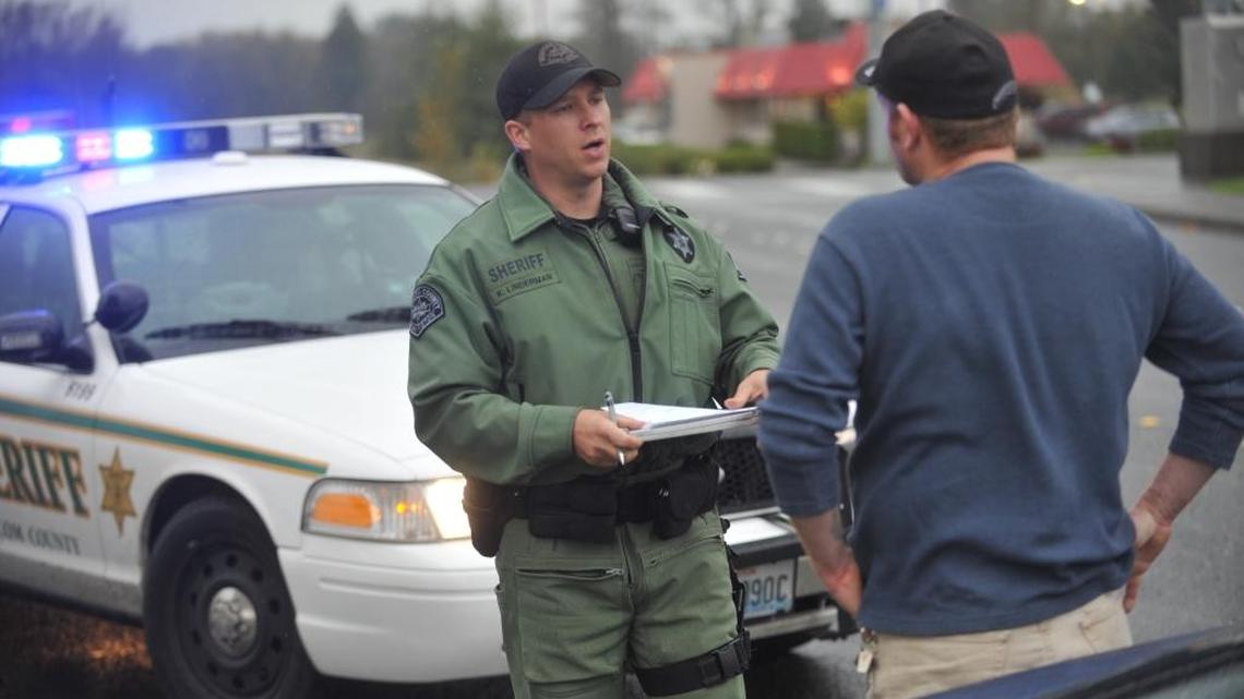 Whatcom County Sheriff’s Deputy Keith Linderman speaks to a motorist after a traffic stop in November 2010. Drivers who receive traffic tickets often can have the violation deferred, betting on themselves that they won’t commit another infraction for a year.