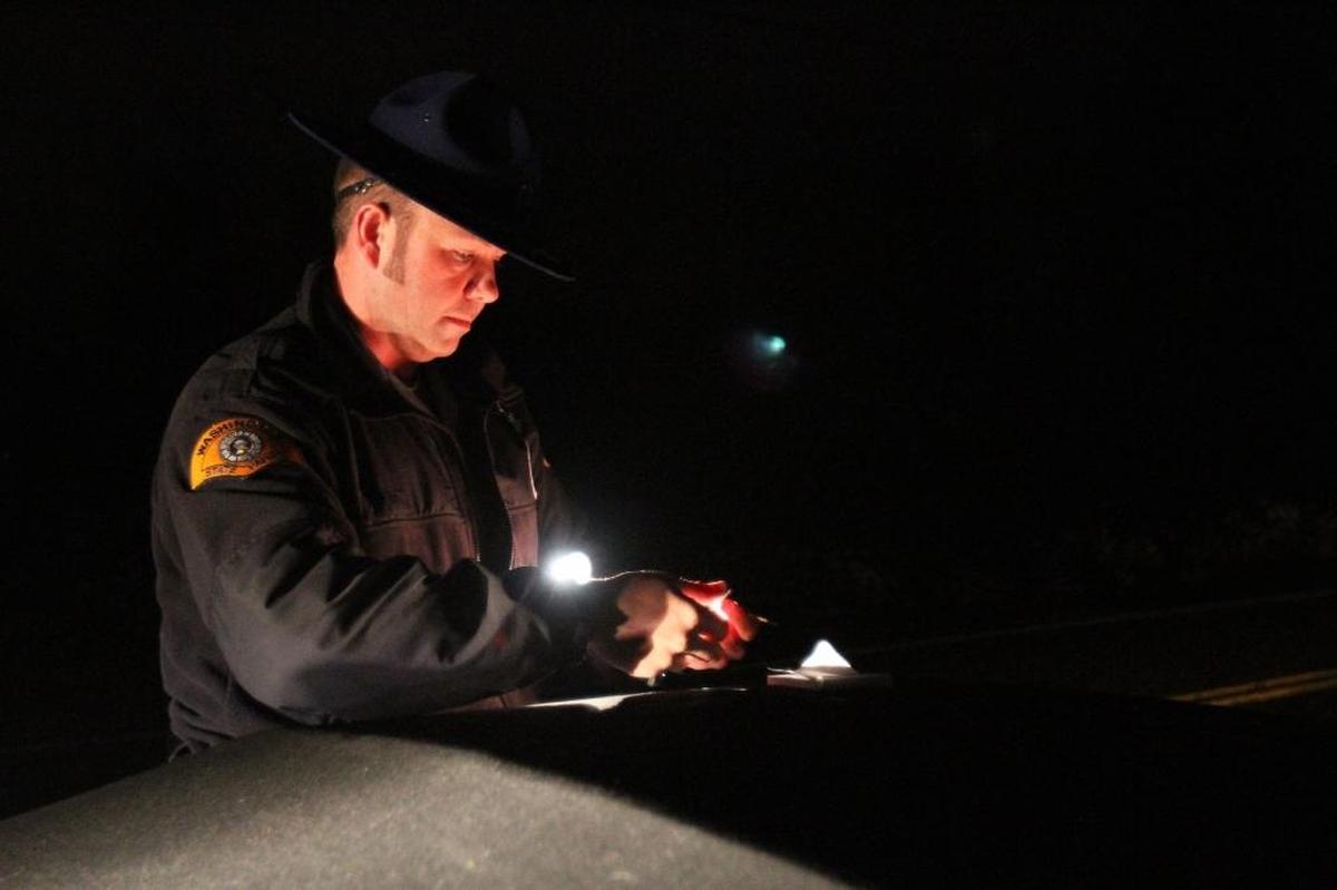 Washington State Patrol Trooper Guy Gill retrieves the personal belongings of a woman arrested on suspicion of driving under the influence off South Bay Road in 2012. Whether it’s alcohol, cannabis, illegal drugs, prescription medication or a combination, here’s the new mindset: If you feel different, you drive different. Most Washingtonians say they do not DUI or DUICA.