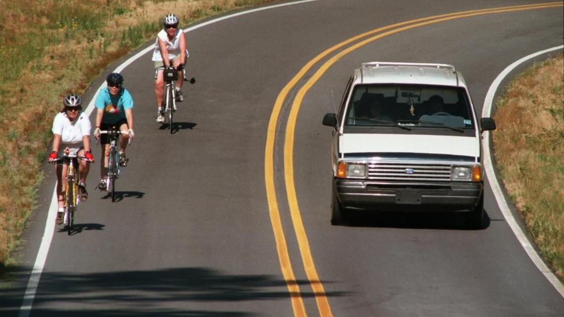 The Revised Code of Washington states drivers may not drive on the left side of the roadway within a no-passing zone, even to pass cyclists.