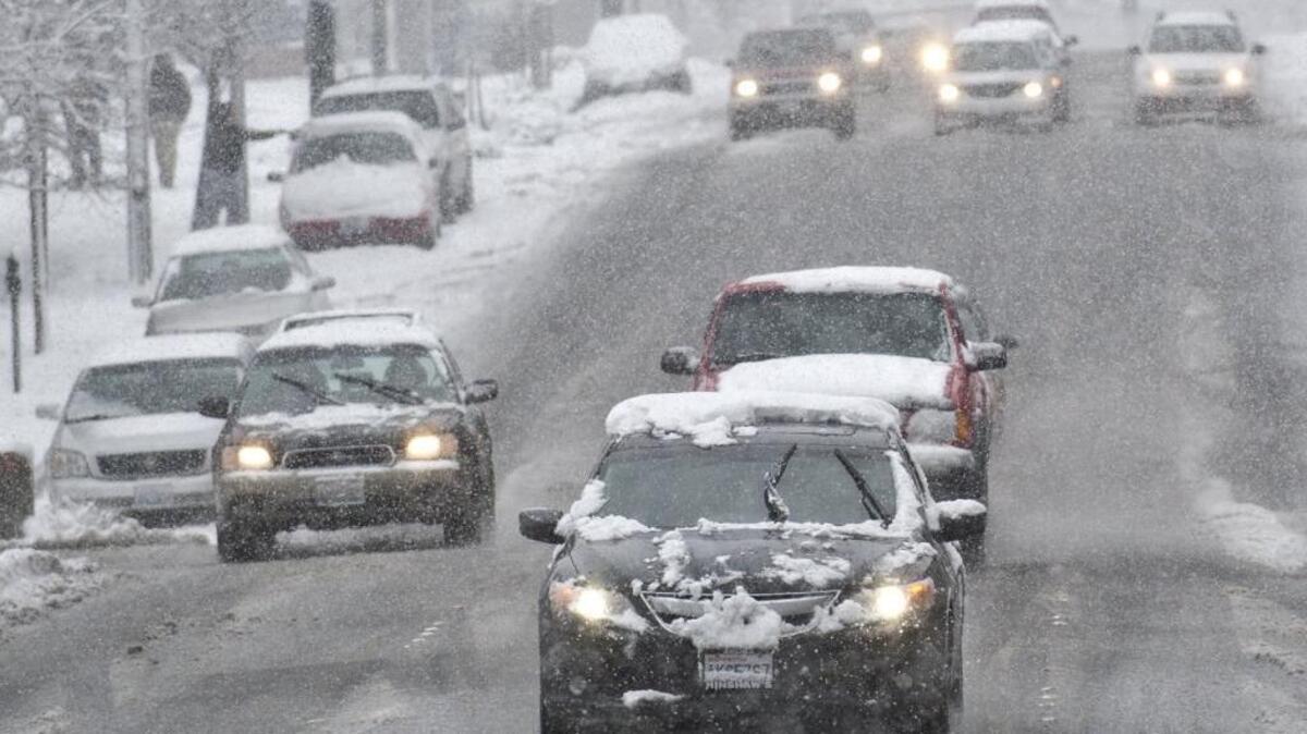 Cars drive down a slushy Holly Street on Feb. 23, 2014, in downtown Bellingham. Good car maintenance and slower speeds are key to driving safely in bad winter weather.