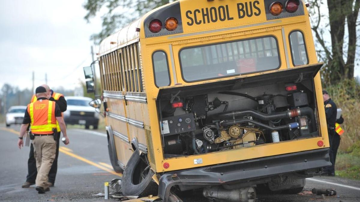 Washington State Patrol officers inspect the site of a crash between a Blaine school bus and a car at the intersection of at Alderson Road and Blaine Road in October 2013. The two people in the car were seriously injured. No one on the bus was hurt.