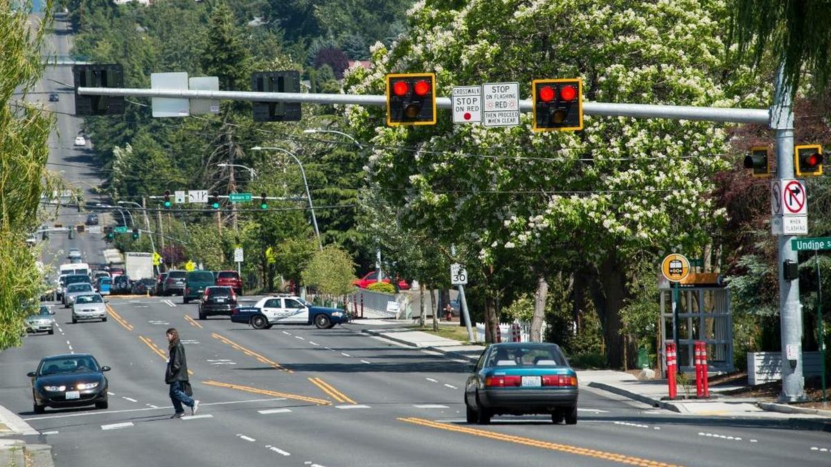 Vehicles stop for a pedestrian crossing Alabama Street at a HAWK signal on Friday, June 17, in Bellingham, Wash.