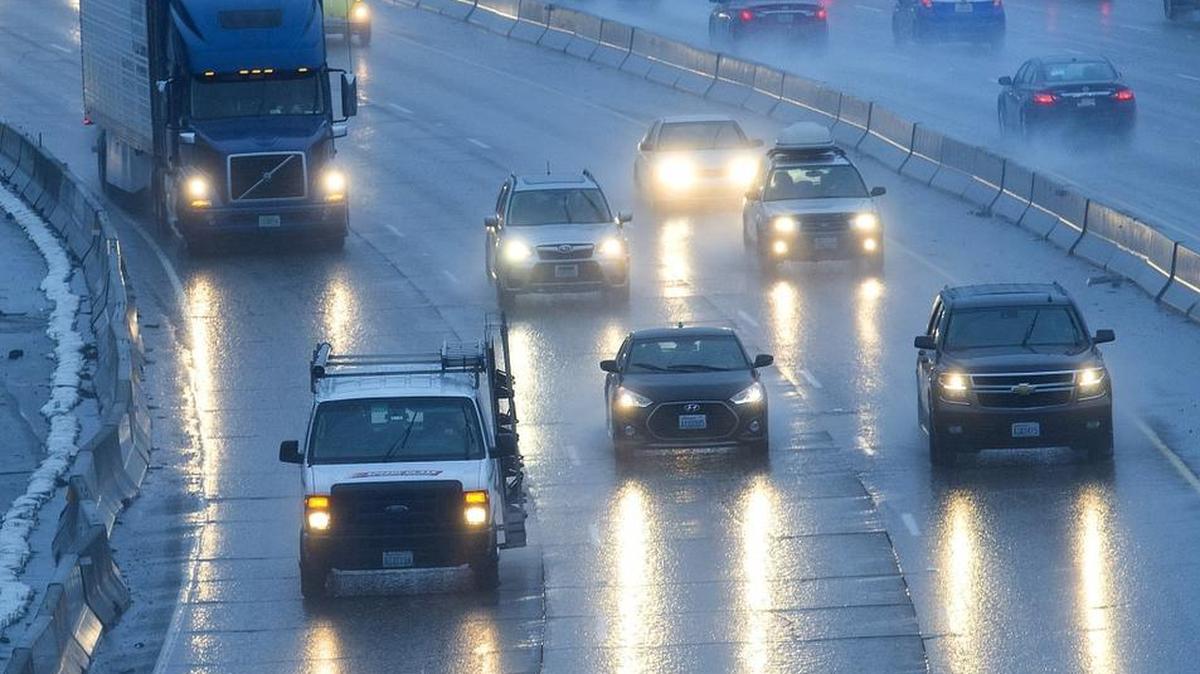 Headlights reflect off the wet pavement on I-5. The brightness of vehicle headlights is limited by the Federal Motor Vehicle Safety Standard. Drivers are required to dim their headlights when approaching an oncoming vehicle within 500 feet or when approaching the rear of a vehicle within 300 feet.