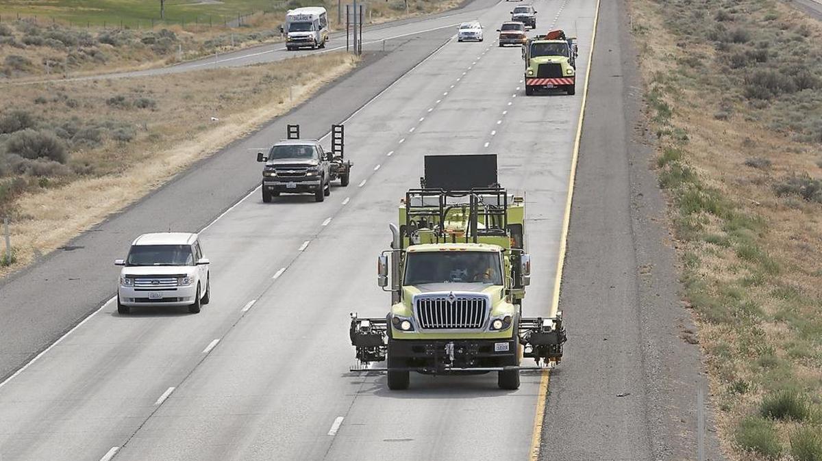 A Washington State Department of Transportation paint striping truck simutaneously sprays the white centerline markings and the yellow edgeline in the westbound lanes of Interstate 82 in Pasco. White lines are used to separate lanes traveling in the same direction and can be broken, dashed, solid or solid double, and each type has rules.