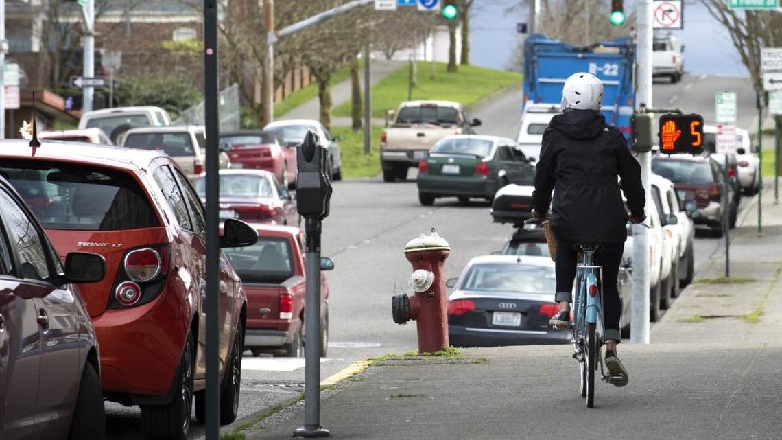 A bike and a pedestrian meet on a sidewalk. No joke, it’s a lesson in right-of-way hierarchy