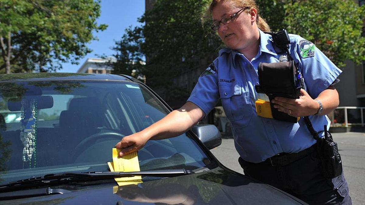 
Lisa DeAnnuntis places a second ticket on a car for improper parking in Bellingham in 2010. It’s illegal to leave a car parked in the same spot on city streets for more than 72 hours. 
