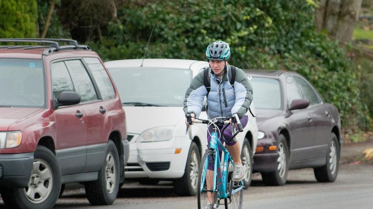 A bicyclist coasts down Billy Frank Jr. Street on Thursday, Feb. 4, in Bellingham, Wash. Helmets aren’t required in Washington state but are recommended for safety.
