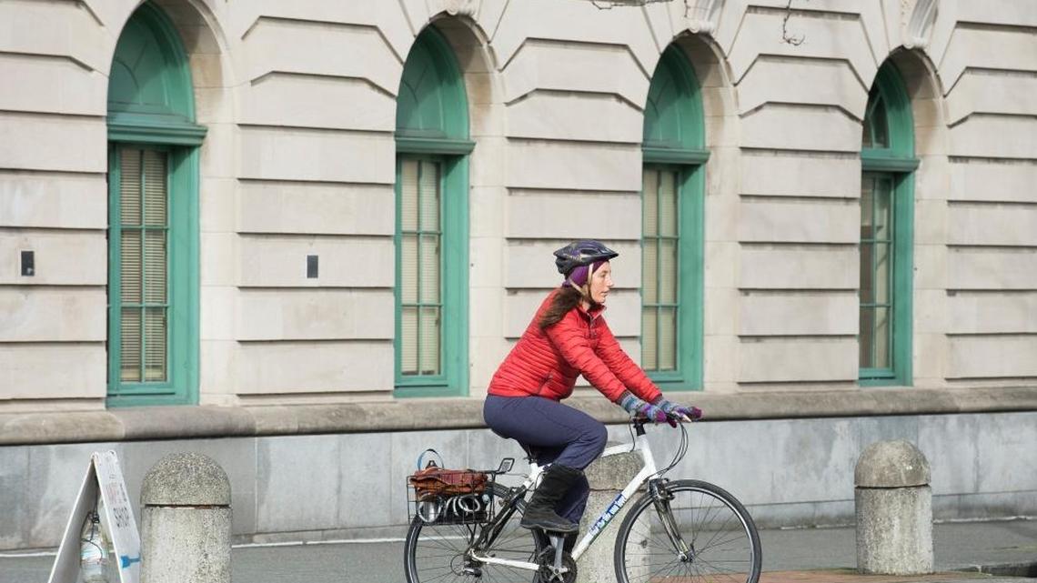 A bicyclist rides across a crosswalk on Magnolia Street in downtown Bellingham.