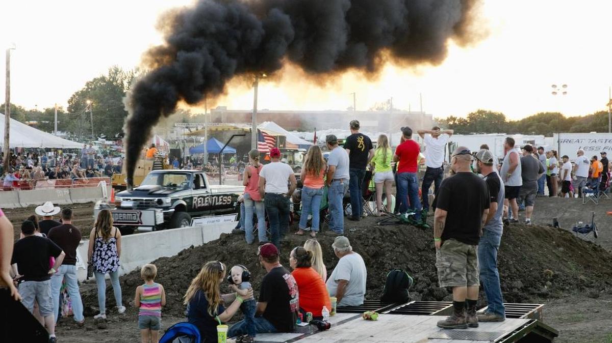 A crowd watches during the Illini State Pullers event at the 2016 McHenry County Fair in Woodstock, Ill. The thick black smoke from the modified engines at the event is also showing up on the nation’s roads, when drivers known as coal rollers, alter their diesel trucks so they spew thick black smoke in a show of defiance.