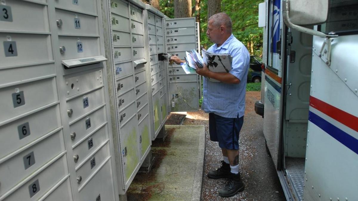 U.S. mail carrier Keith Koenig delivers the mail to a cluster of mailboxes near Gate 2 in Sudden Valley in 2008. In Whatcom County, Bellingham and Blaine include sections in their municipal codes that prohibit parking in front of mailboxes, and Ferndale may soon pass one. But the Revised Code of Washington makes no mention of it.