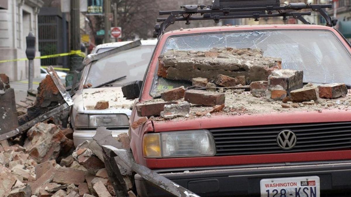 Bricks that fell from an earthquake cover parked cars in Seattle’s Pioneer Square district on Feb. 28, 2001, after the powerful Nisqually earthquake. If you’re driving during an earthquake, pull over and stop but avoid stopping near a tall building or under a bridge because they could collapse or have debris fall and hit your car.