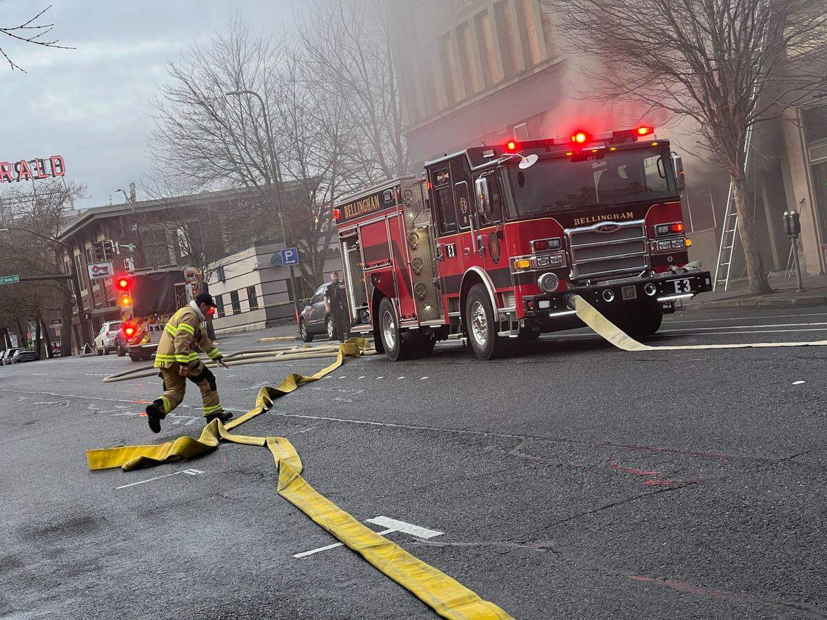 A firefighter prepares a hose as crews battle a fire at the State Street Bar on Wednesday, Jan. 3.