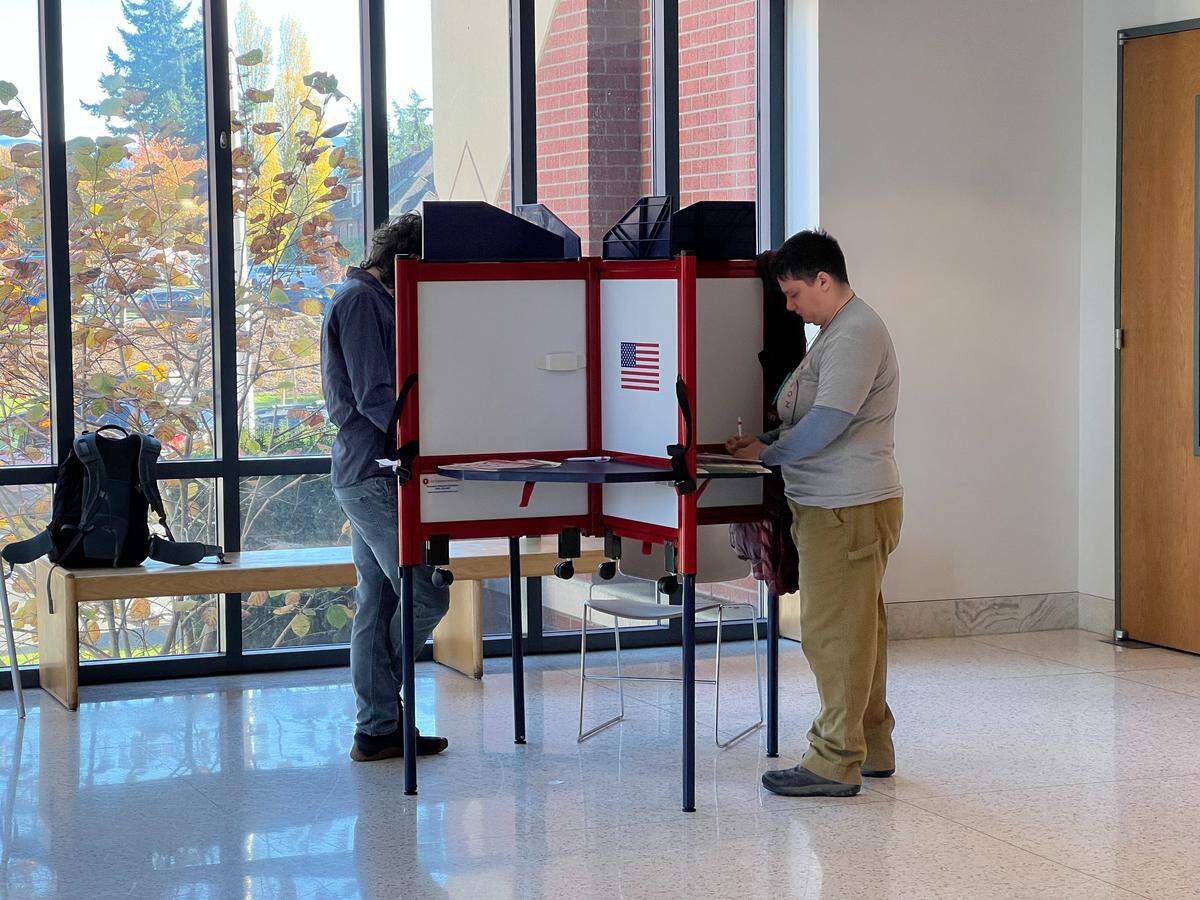 Voters mark their ballots in the rotunda of the Whatcom County Courthouse in Bellingham on Nov. 4. Ballot booths are provided on Election Day for those who want the experience of in-person voting even though Washington votes by mail. Ballot drop boxes are available in the courthouse and outside for drive-up ballot deposits.