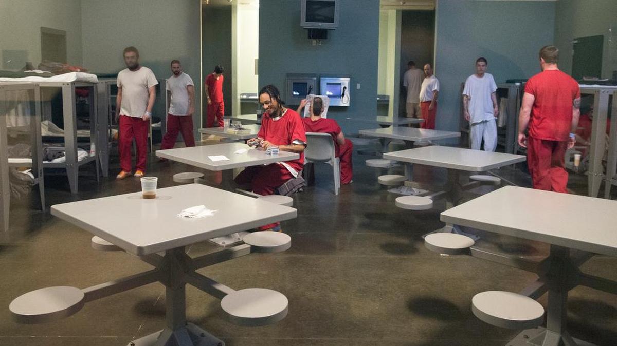 
Minimum security inmates read, play cards and walk around a 32-person housing unit at Whatcom County Jail’s Interim Work Center on June 30 in Bellingham.
