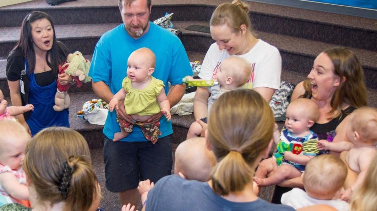 
Children’s Library Specialist Bernice Chang, far left, talks to parents about the five early literacy practices — talking, singing, reading, writing and playing — during Baby Time at the Bellingham Public Library. 
