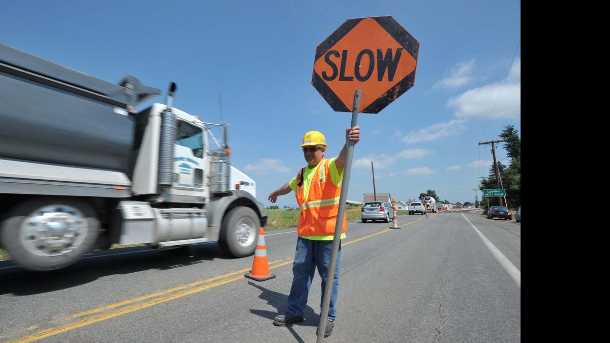 
A flagger directs traffic through construction on Badger Road north of Lynden in 2013.
