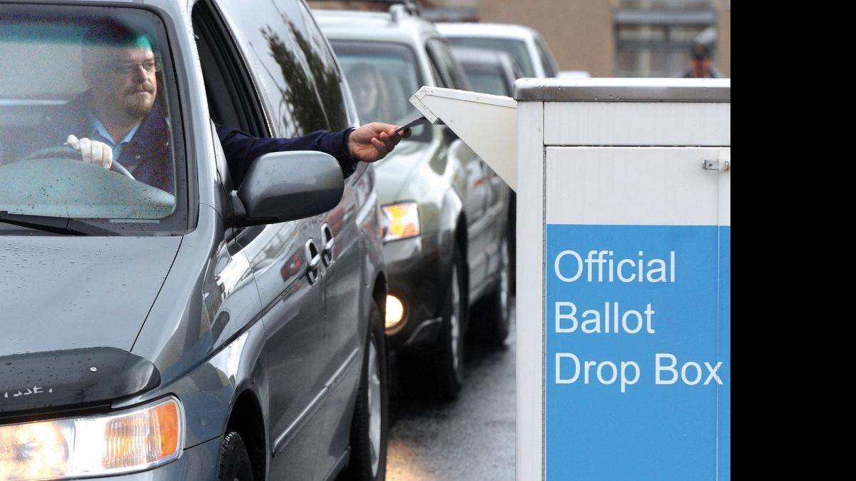 
A voter drops off his ballot at the drop box at the Whatcom County Courthouse South Parking Lot, 201 Grand Ave. in 2011.
