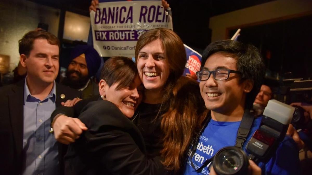 Danica Roem, center, who ran for house of delegates against GOP incumbent Robert Marshall, is greeted Nov. 7, 2017, by supporters as she prepares to give her victory speech with Prince William County Democratic Committee at Water’s End Brewery in Manassas, Va. Transgender woman Roem, whose defeat of an outspoken, socially conservative lawmaker has made news around the world, is just one of several women who made history in this week’s Virginia elections. The state House is also getting its first Latina members, its first Asian-American woman delegate and likely its first openly lesbian member.